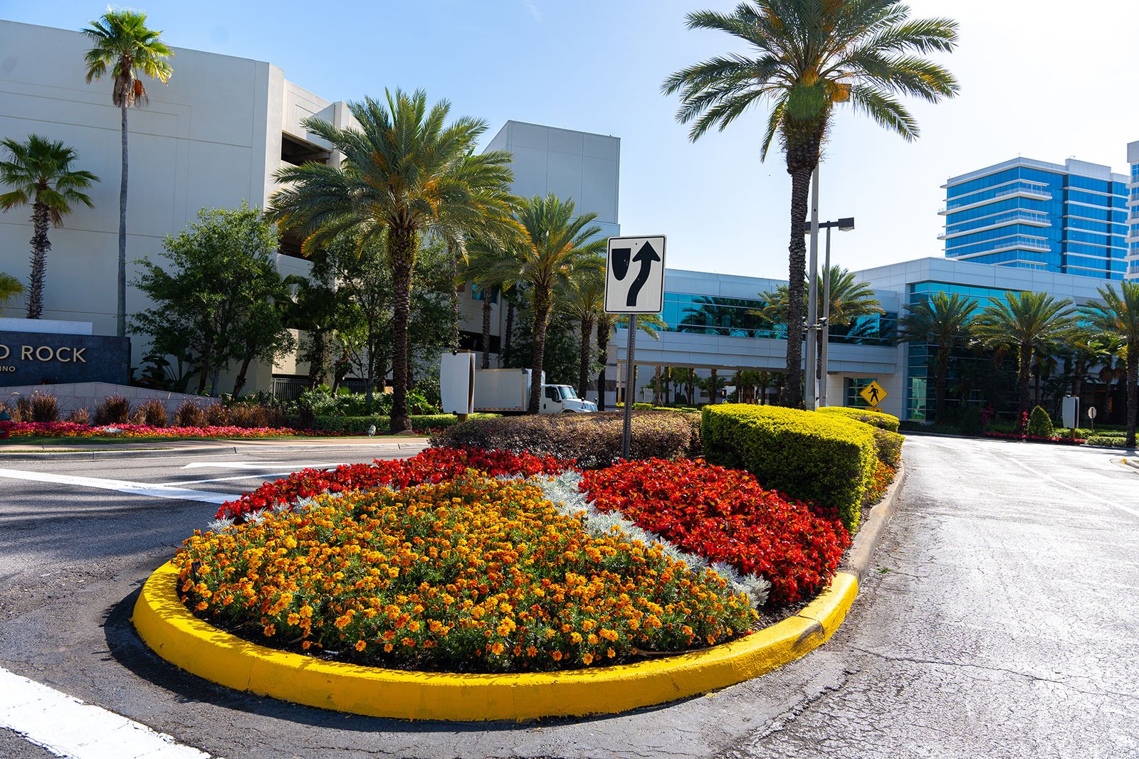 Hard Rock Cafe property roundabout with bold red and gold seasonal flower display